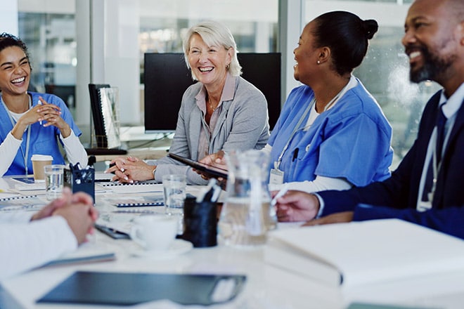 group of medical professionals in a conference room working together