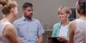 outpatient opioid treatment program - individuals and doctor rallying behind a patient