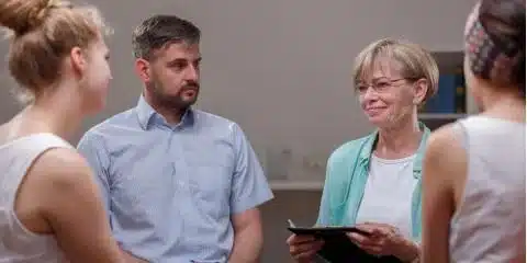 outpatient opioid treatment program - individuals and doctor rallying behind a patient