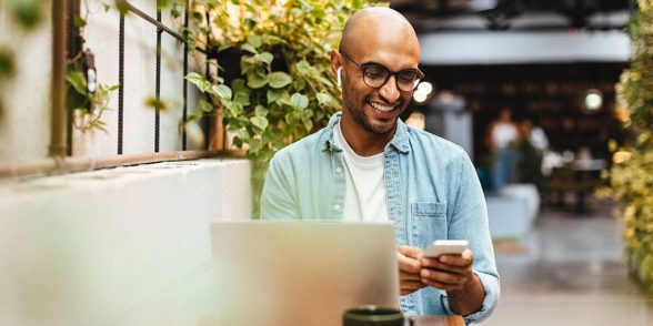 man on a smartphone at a coffee shop