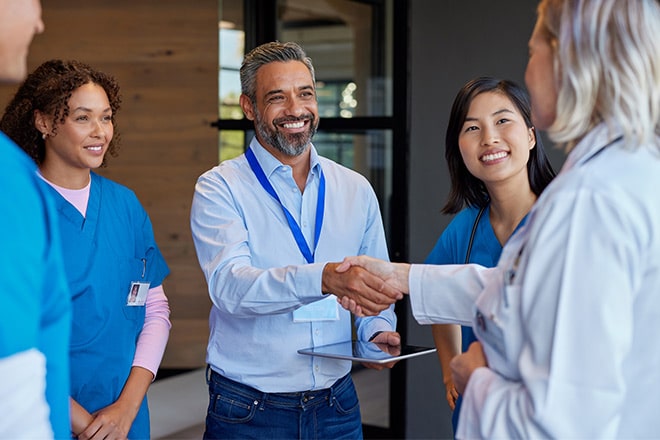 doctors and nurses shaking hands