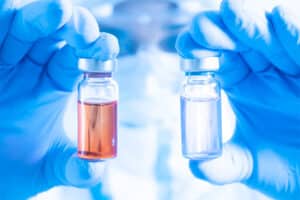 doctor holding two medications: Sublocade and Vivitrol