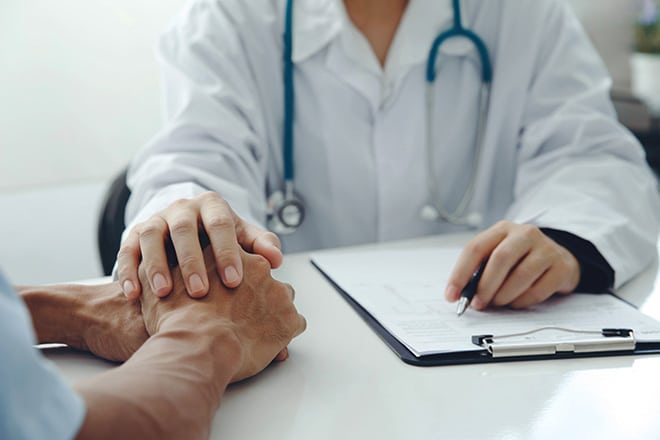 doctor holding a patient's hand as they continue their Suboxone or Vivitrol treatment at Brightside